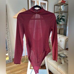Red turtleneck body suit